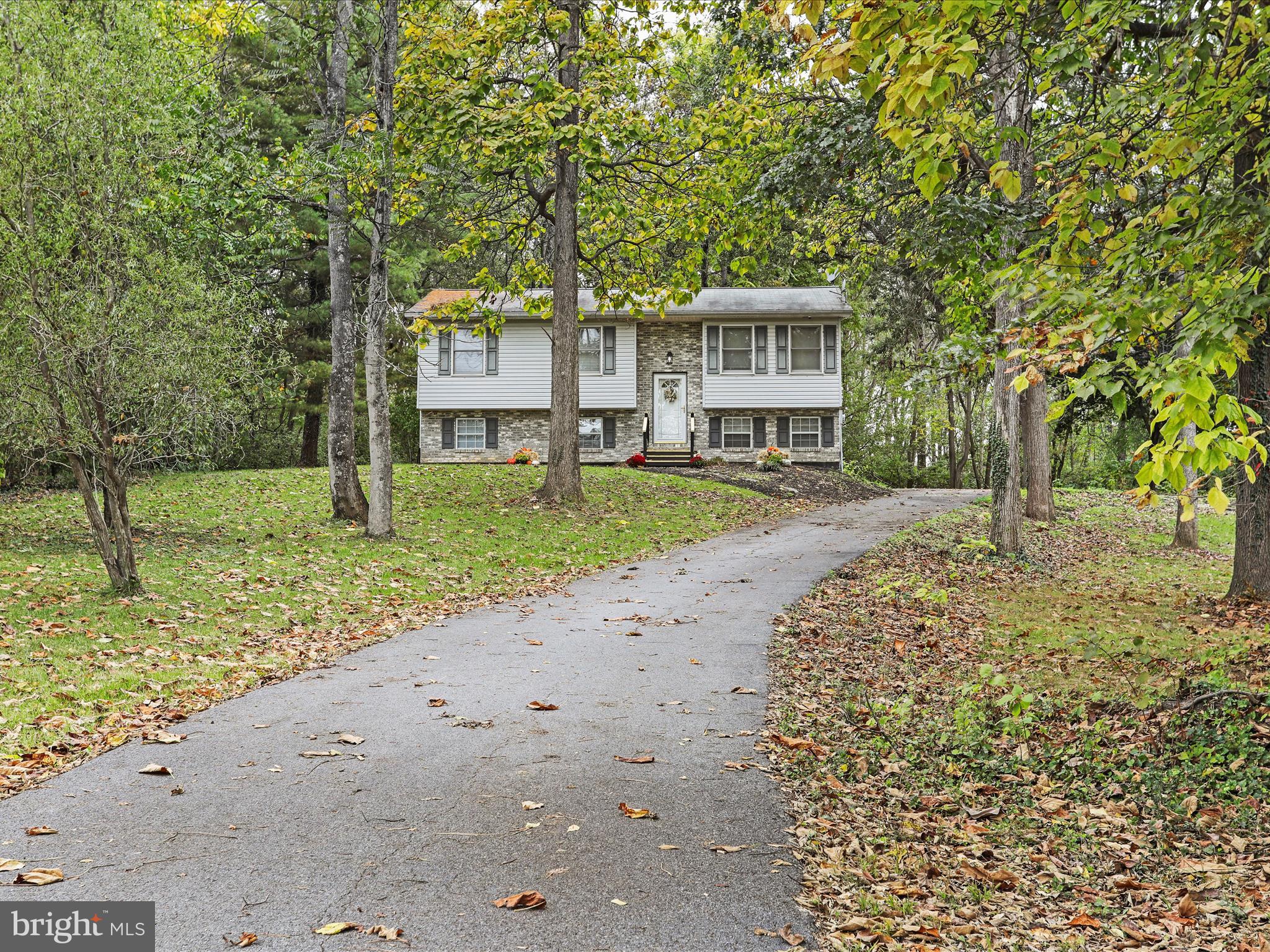 95 Traveller Road Falling Waters, WV 25419 - Photo 3 of 42 a front view of a house with a yard and garage