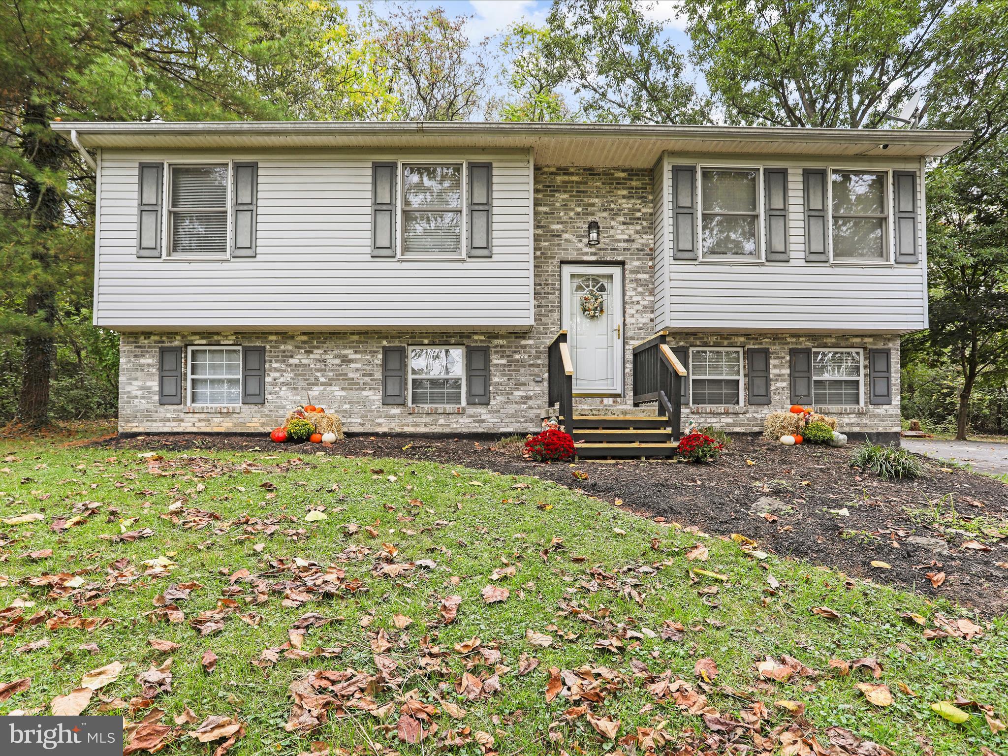 95 Traveller Road Falling Waters, WV 25419 - Photo 4 of 42 a front view of a house with garden