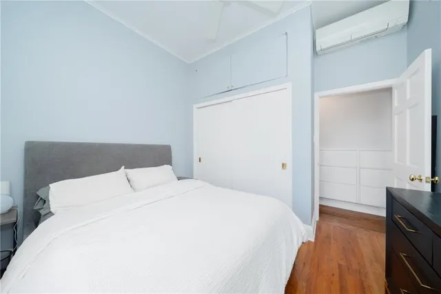 a bedroom with a bed and a flat tv screen