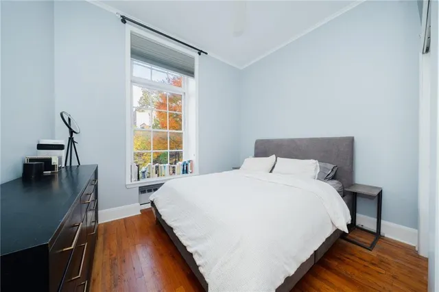 a large bed sitting in a bedroom next to a window