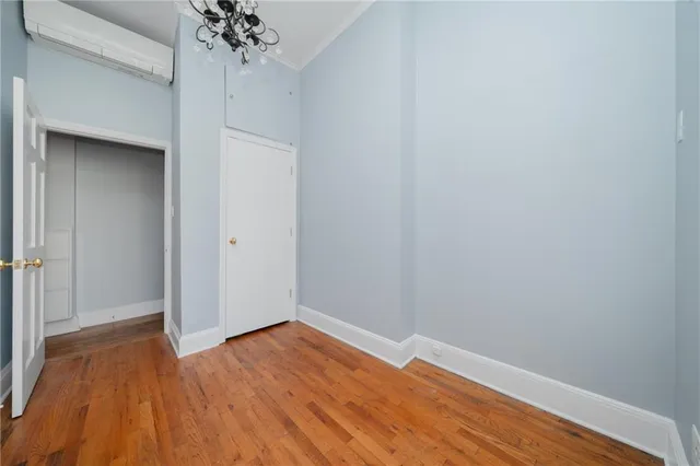 a view of a room with wooden floor