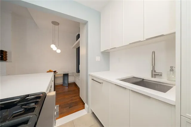 a kitchen that has a sink and a stove