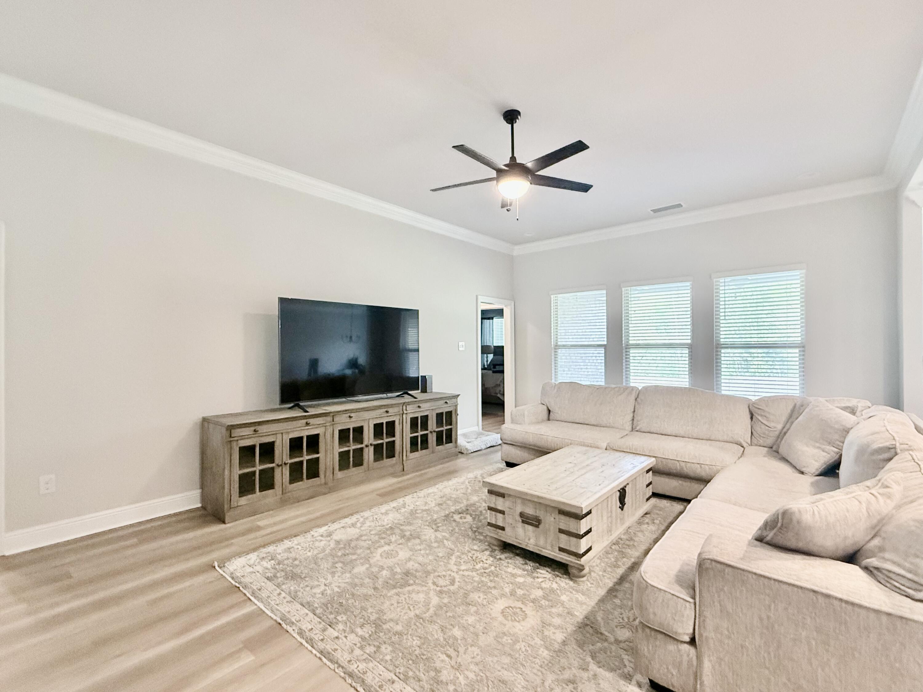 4603 Jayhawk Drive Crestview, FL 32539 - Photo 12 of 41 a living room with furniture and a flat screen tv