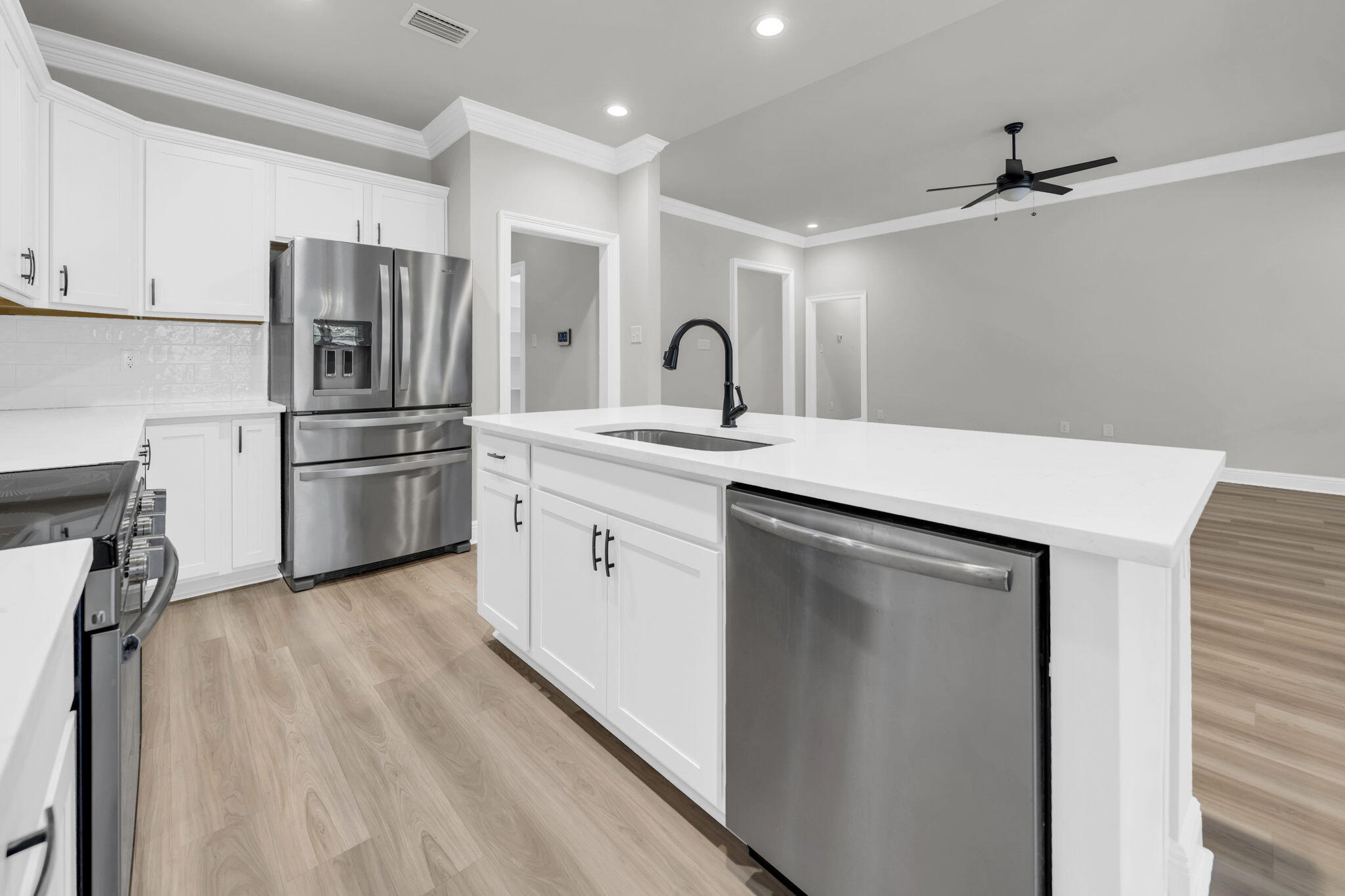 4603 Jayhawk Drive Crestview, FL 32539 - Photo 14 of 41 a kitchen with stainless steel appliances a refrigerator sink and cabinets