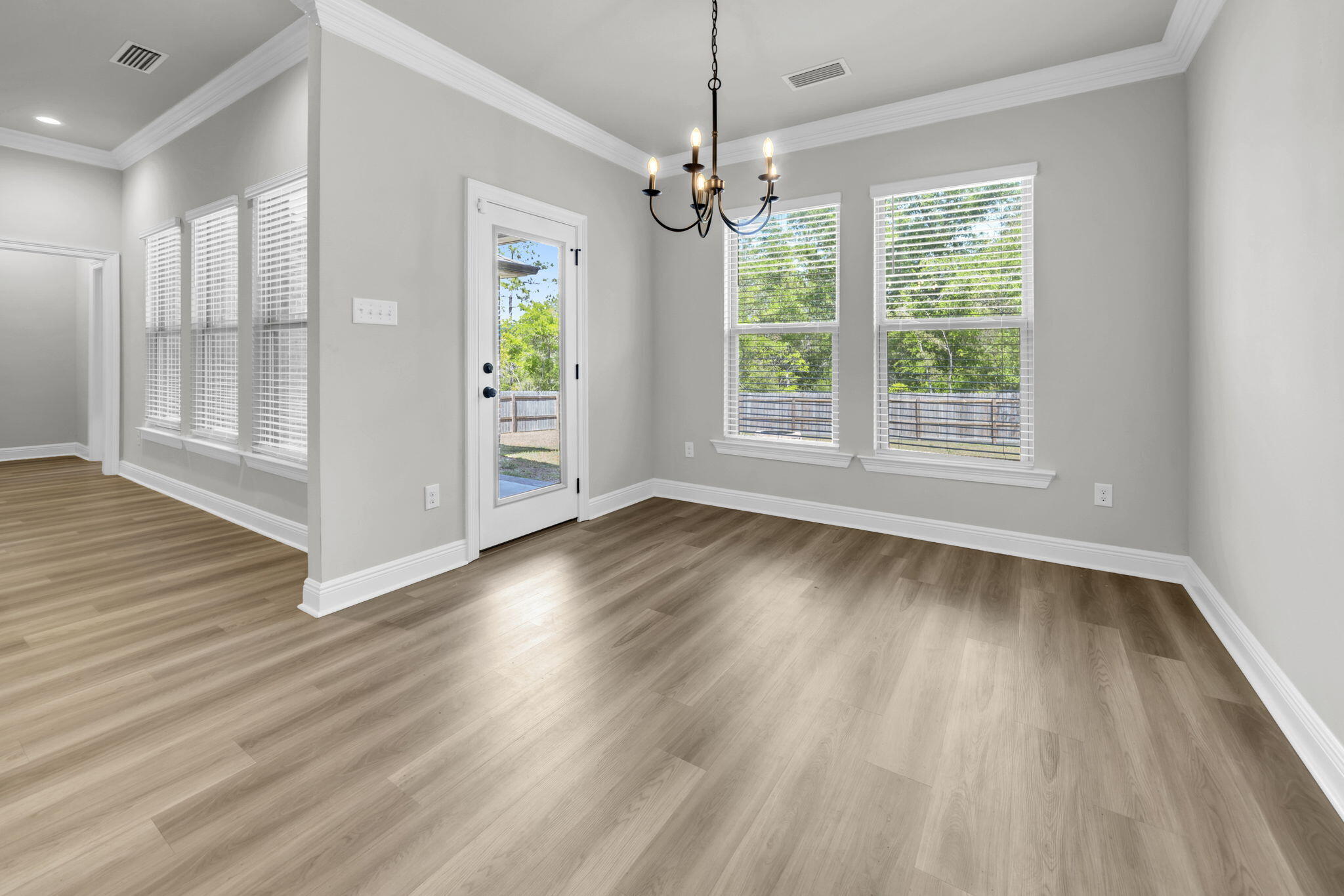 4603 Jayhawk Drive Crestview, FL 32539 - Photo 18 of 41 a view of an empty room with wooden floor and a window