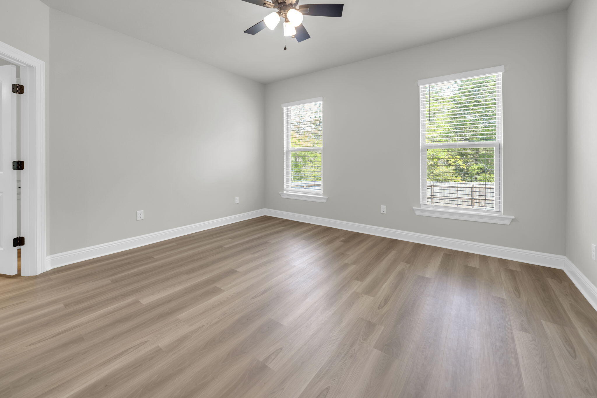 4603 Jayhawk Drive Crestview, FL 32539 - Photo 24 of 41 a view of an empty room with wooden floor and a window