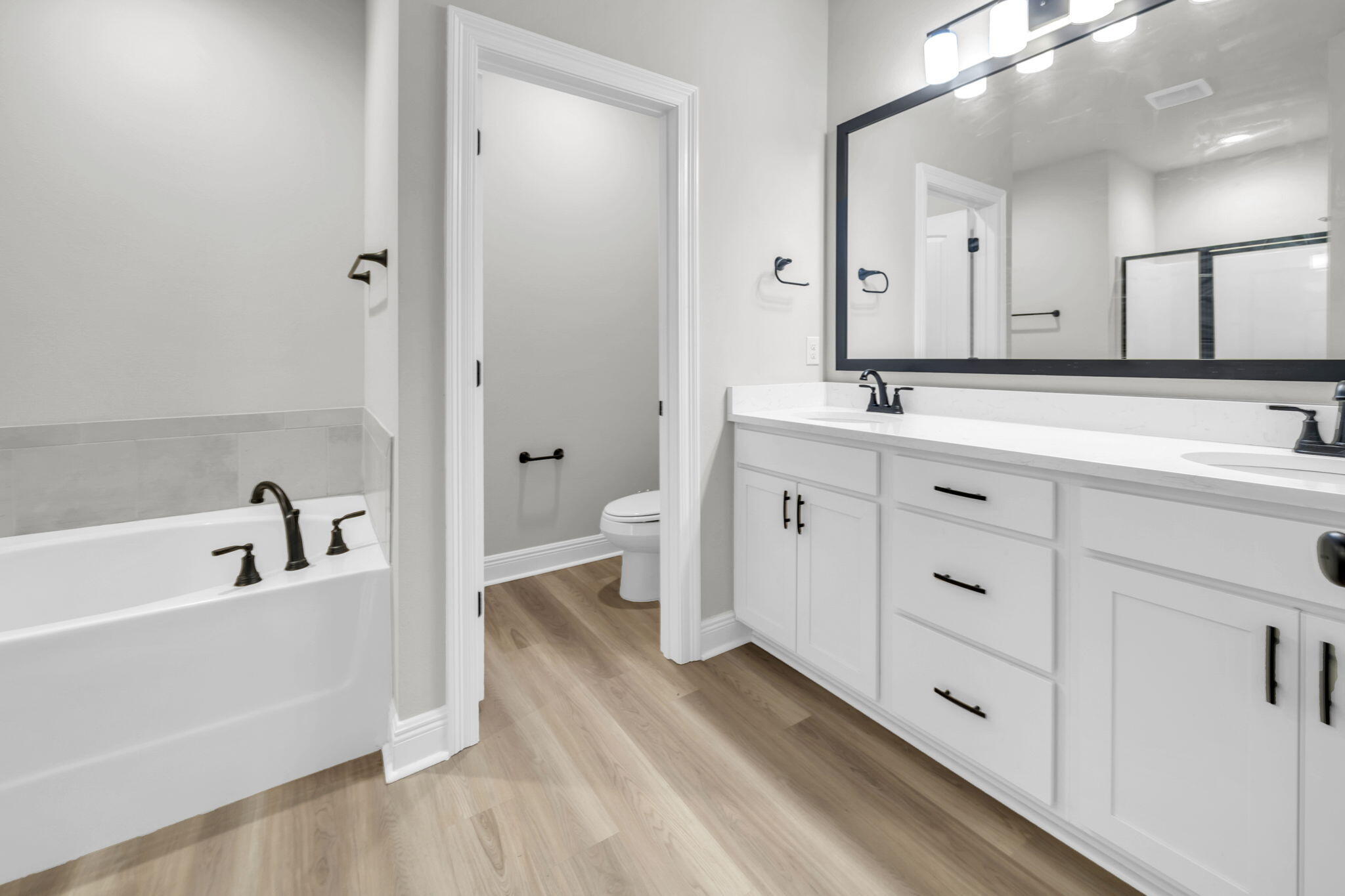 4603 Jayhawk Drive Crestview, FL 32539 - Photo 26 of 41 a spacious bathroom with a double vanity sink a mirror and a bathtub