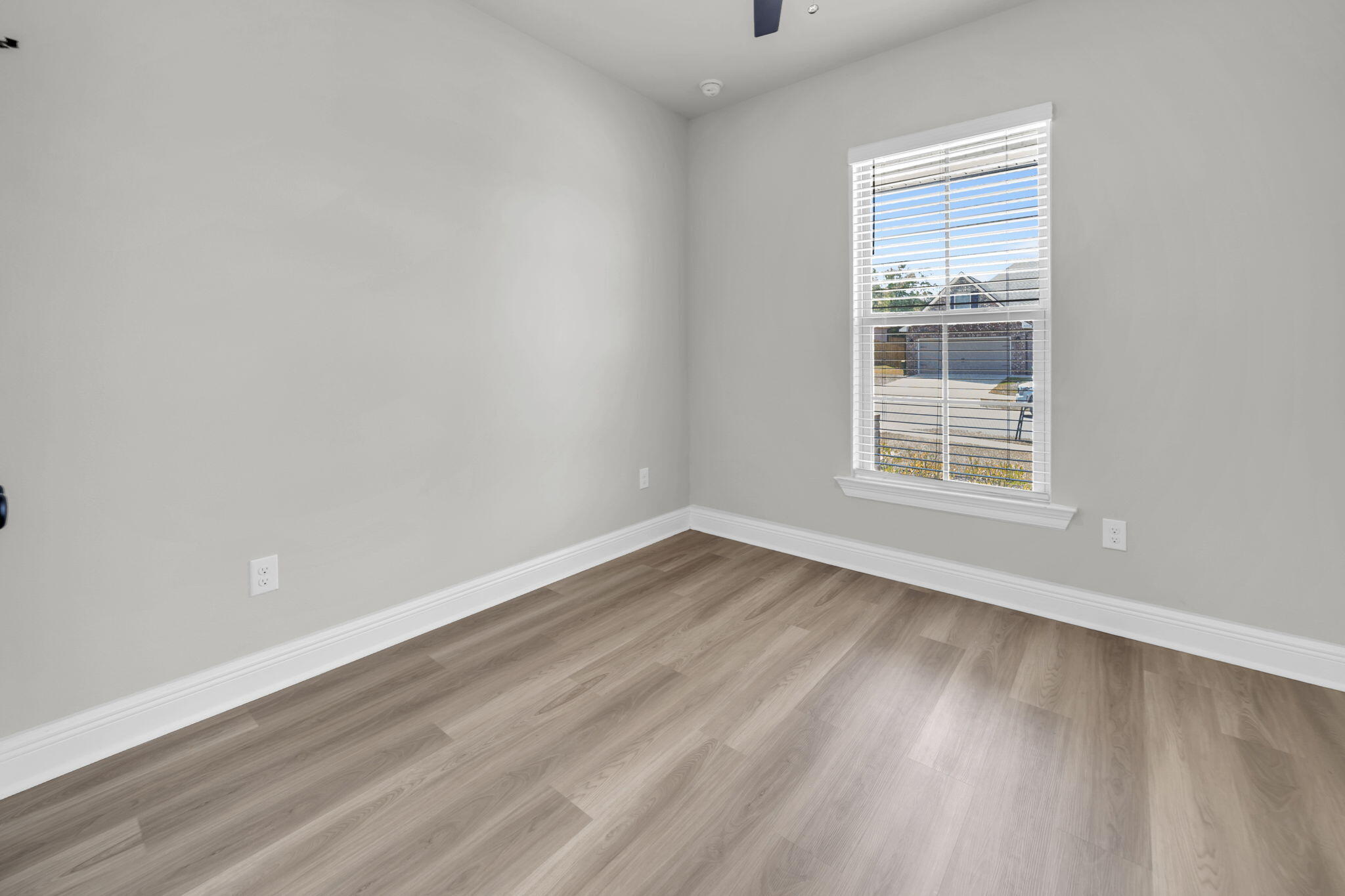 4603 Jayhawk Drive Crestview, FL 32539 - Photo 31 of 41 an empty room with wooden floor and windows