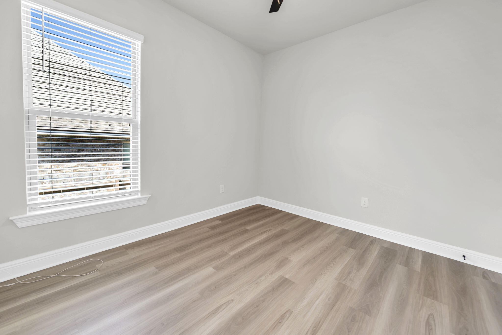 4603 Jayhawk Drive Crestview, FL 32539 - Photo 33 of 41 a view of an empty room with wooden floor and a window