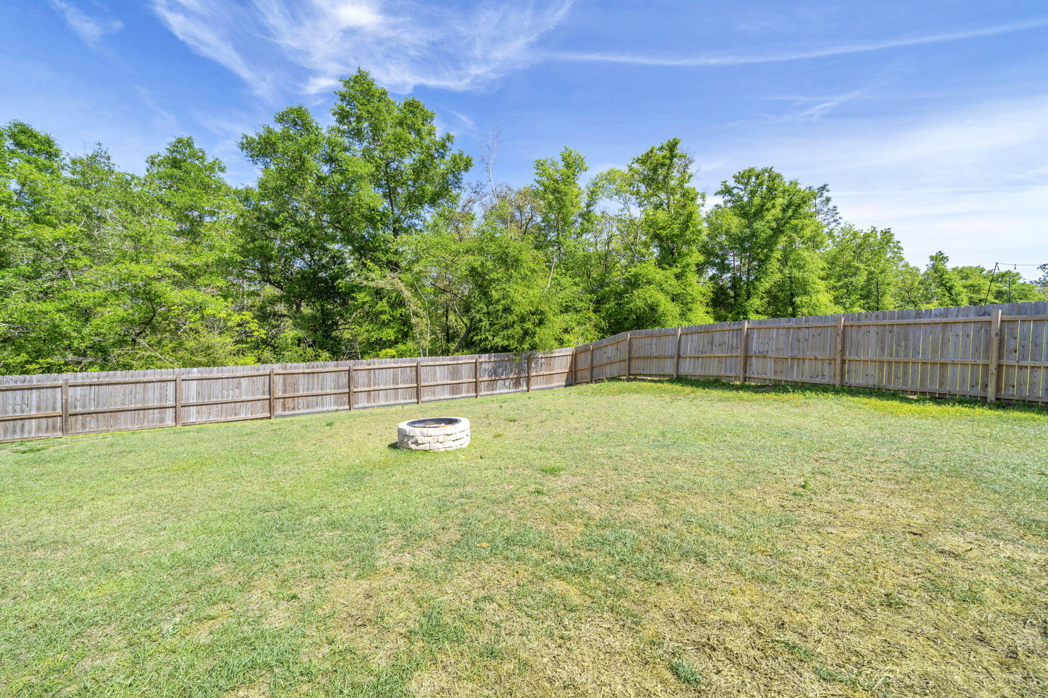 4603 Jayhawk Drive Crestview, FL 32539 - Photo 39 of 41 a view of a backyard with a plants and trees