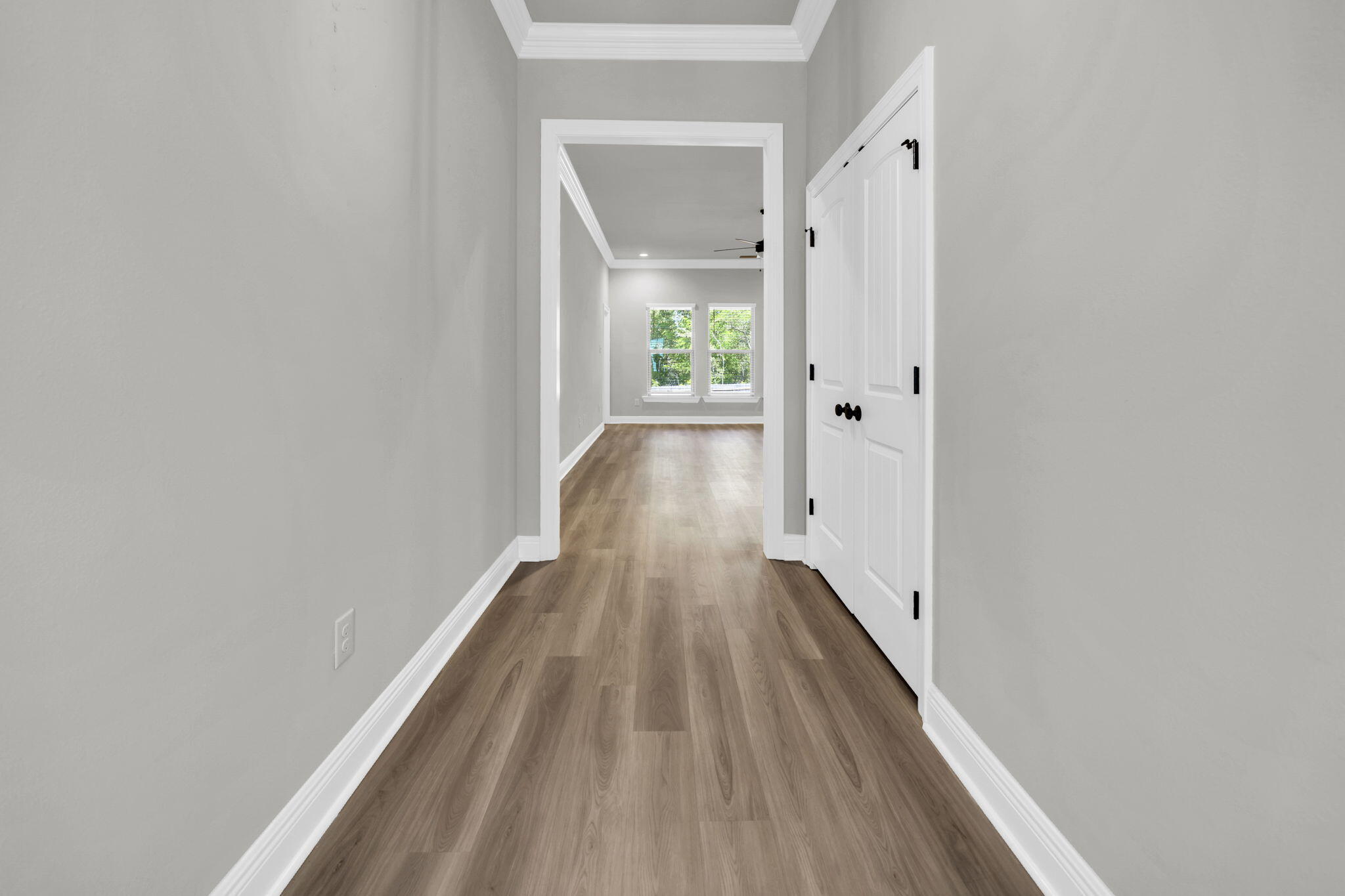 4603 Jayhawk Drive Crestview, FL 32539 - Photo 7 of 41 a view of a hallway with wooden floor and a bathroom