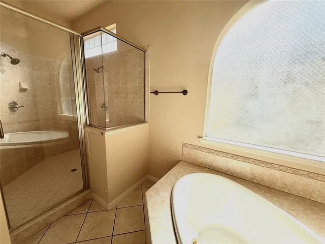 a bathroom with a tub and shower