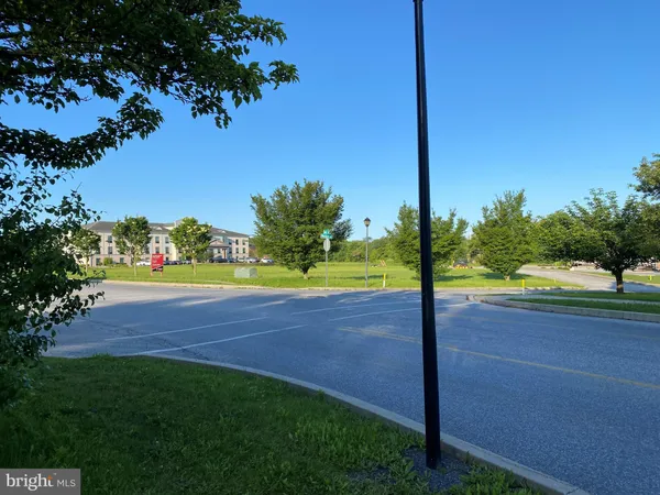a view of a street with a big yard