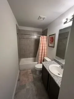 a bedroom with two beds and painting on the wall