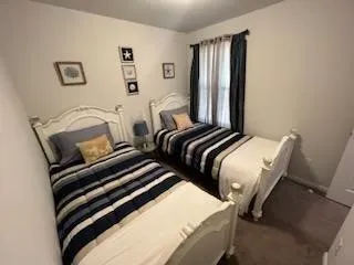 a bedroom with two beds and a large mirror