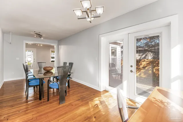 a view of a dining room with furniture and wooden floor