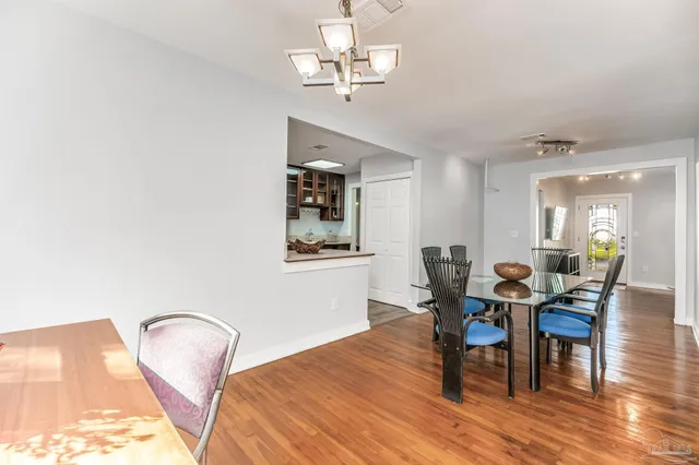 a view of a dining room with furniture and wooden floor