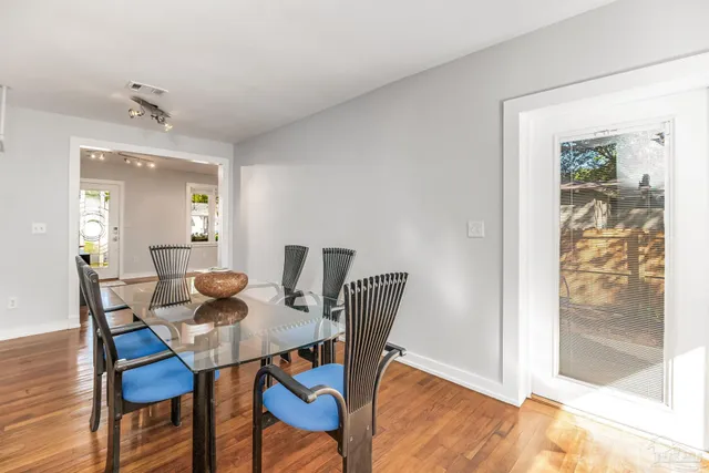 a kitchen with stainless steel appliances granite countertop wooden floors and view living room