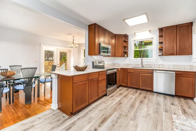 a kitchen with stainless steel appliances granite countertop a stove microwave and sink