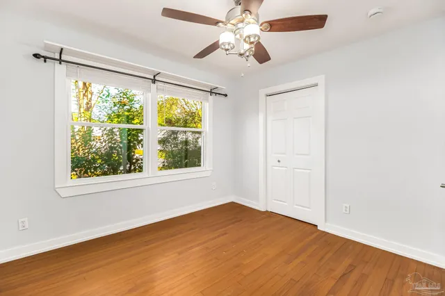 a bathroom with a granite countertop toilet sink and mirror
