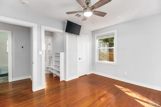 a view of an empty room and wooden floor