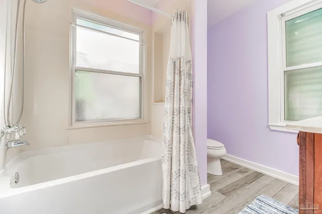 a view of a balcony with floor to ceiling windows and garden