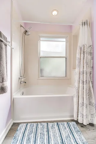 a patio with table and chairs and potted plants