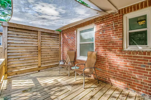 a view of a house with wooden fence