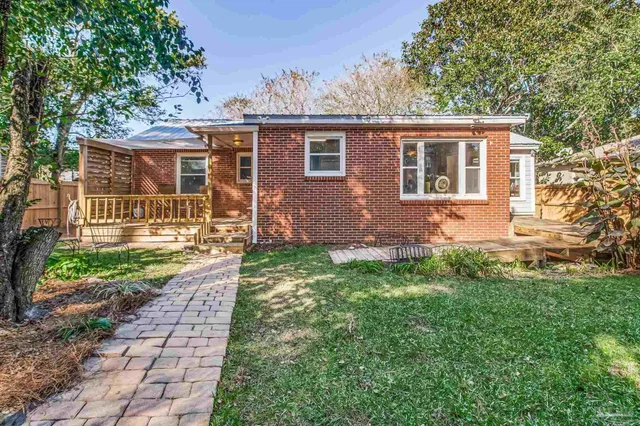 a view of a house with a yard and sitting area