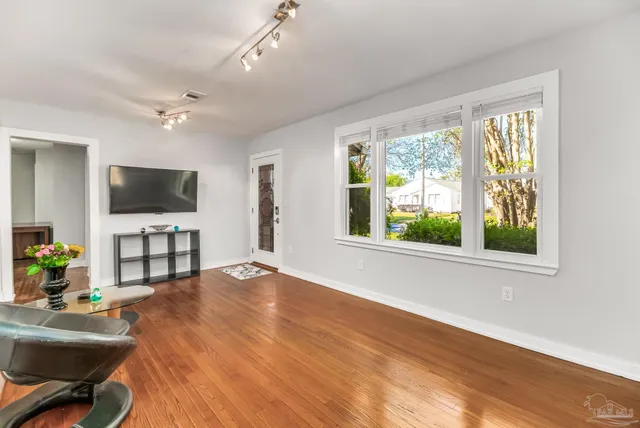 a living room with furniture and a flat screen tv