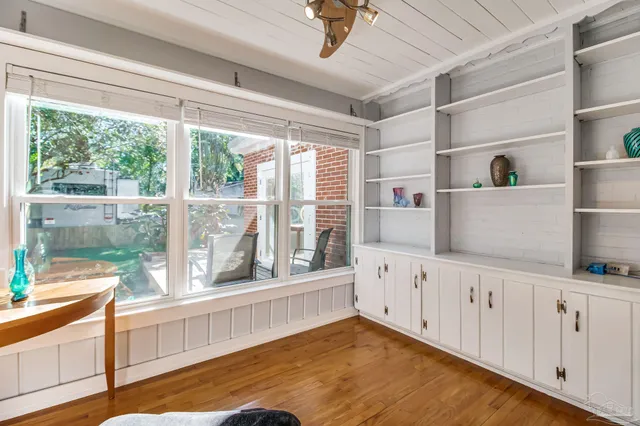 a kitchen with cabinets and wooden floor