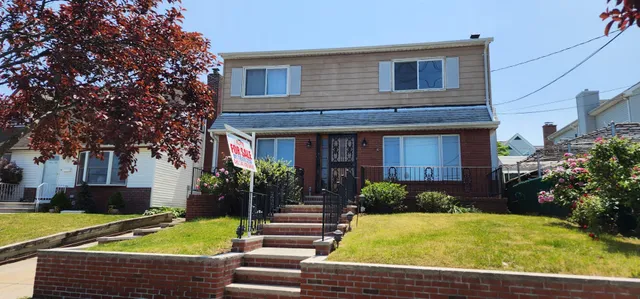 a view of a house with pool and chairs