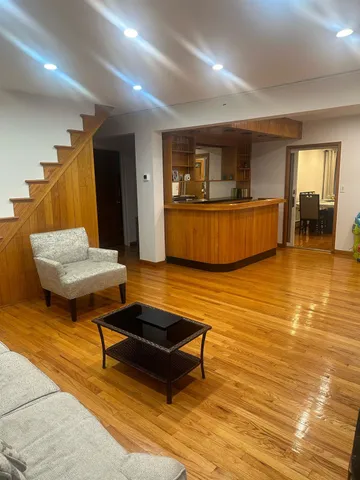 a living room with furniture and a pool table