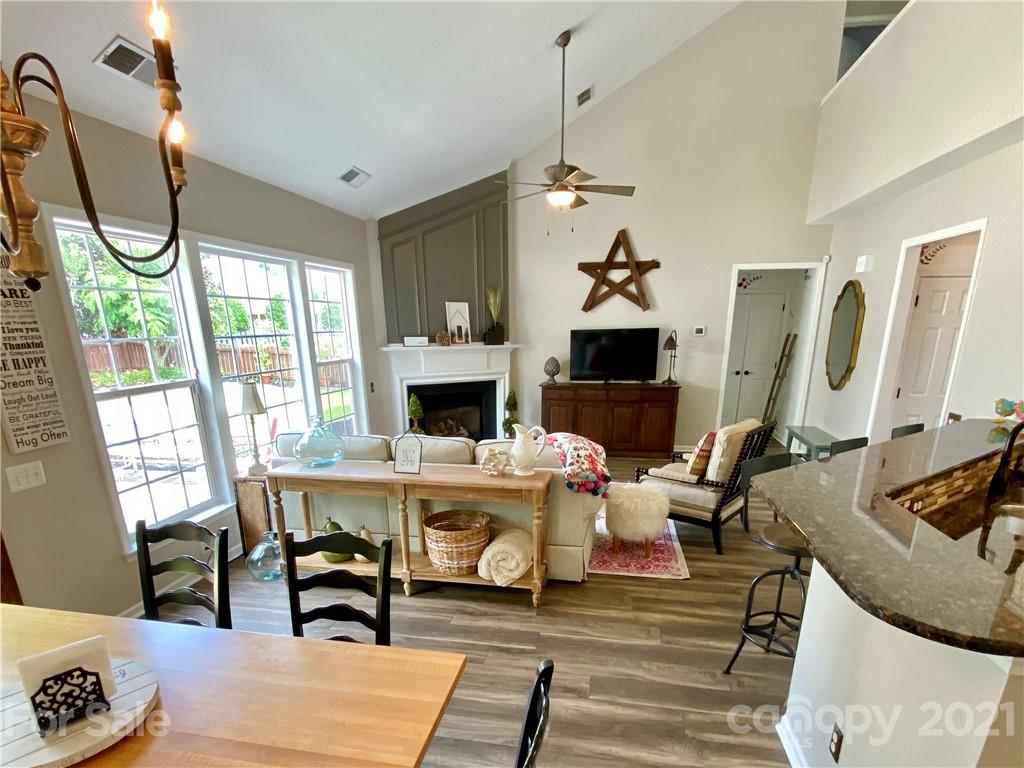 2605 Stirrup Ridge Lane Charlotte, NC 28270 - Photo 11 of 27 a living room with furniture a fireplace and a floor to ceiling window