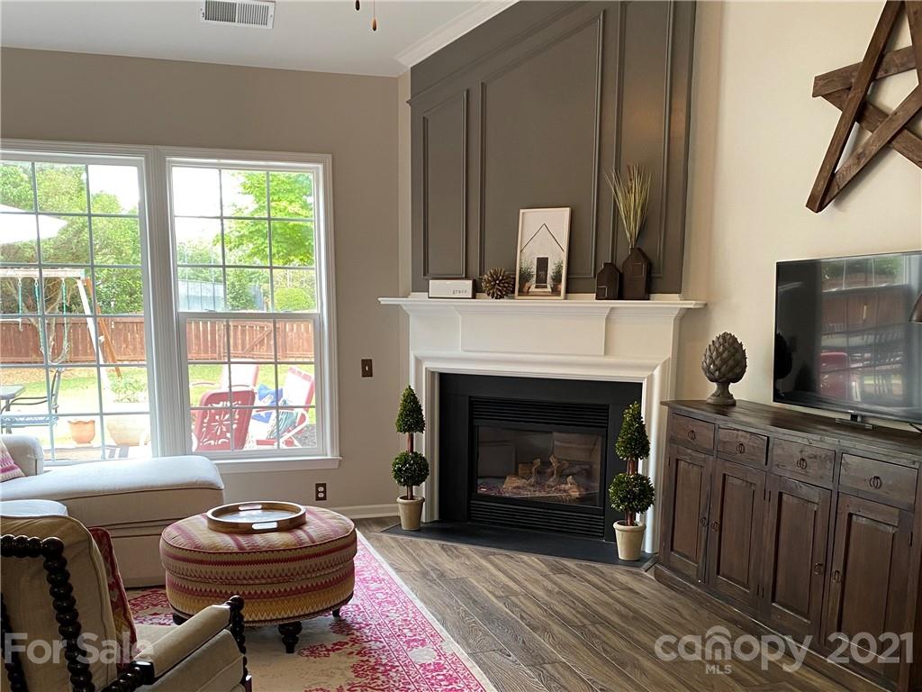 2605 Stirrup Ridge Lane Charlotte, NC 28270 - Photo 12 of 27 a living room with furniture a fireplace and a window