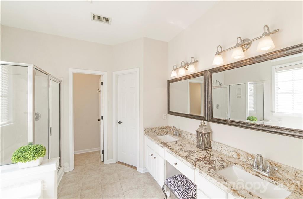 2605 Stirrup Ridge Lane Charlotte, NC 28270 - Photo 15 of 27 a bathroom with a granite countertop sink and a mirror