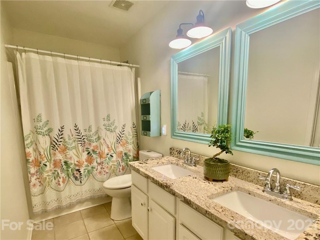 2605 Stirrup Ridge Lane Charlotte, NC 28270 - Photo 23 of 27 a bathroom with a granite countertop sink toilet and shower