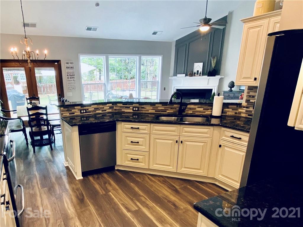 2605 Stirrup Ridge Lane Charlotte, NC 28270 - Photo 7 of 27 a kitchen with granite countertop a stove a sink and a refrigerator
