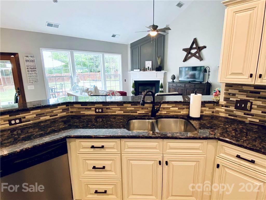 2605 Stirrup Ridge Lane Charlotte, NC 28270 - Photo 9 of 27 a kitchen with granite countertop a sink stove and cabinets