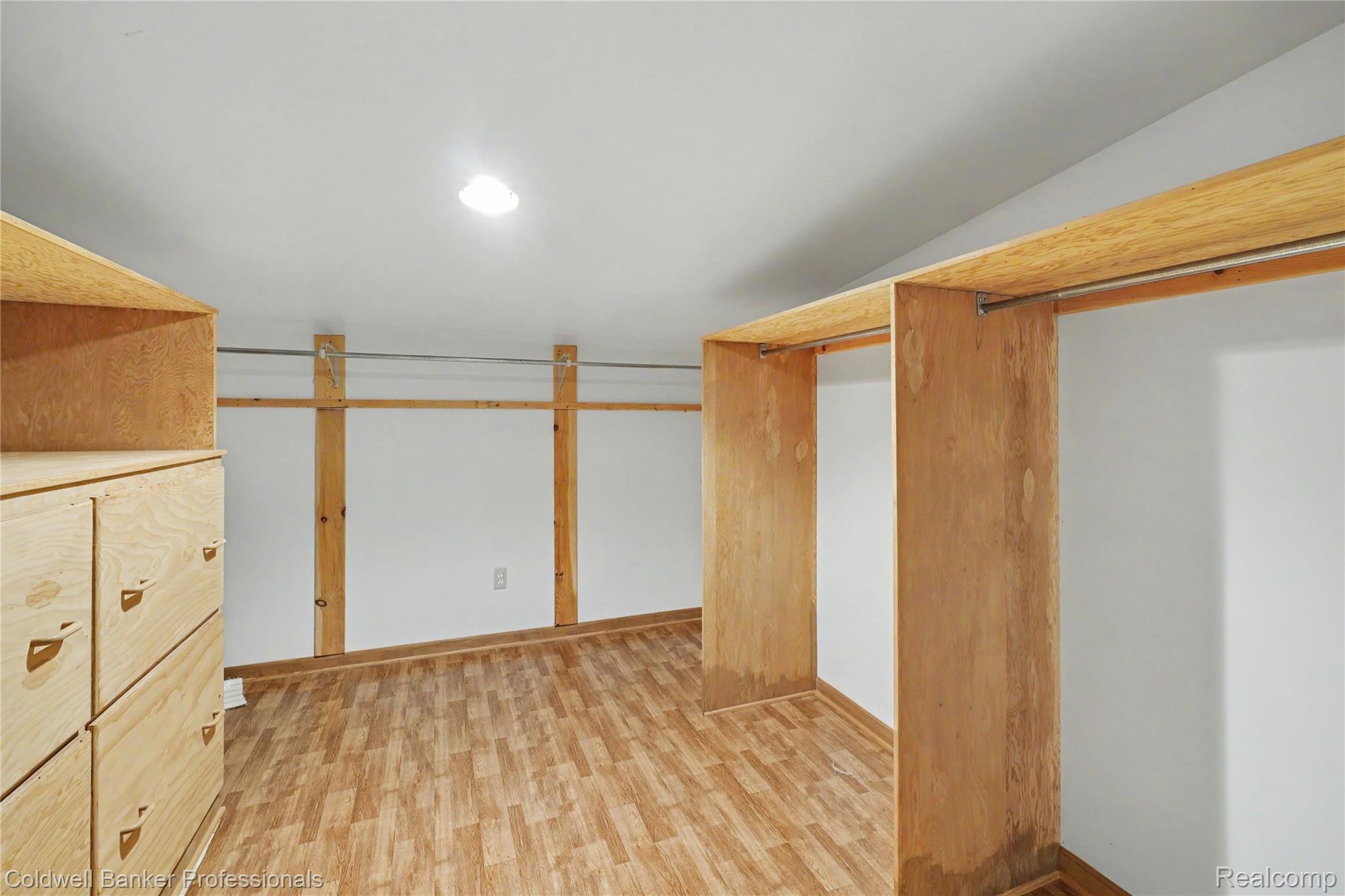 3583 Mitchell Road Metamora, MI 48455 - Photo 47 of 58 Customizable closet space featuring wood-finish flooring, built-in shelving, and integrated hanging rods