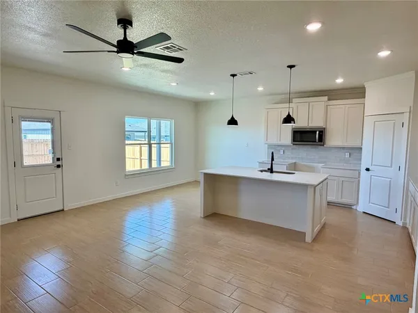 a view of a kitchen with a sink and a window