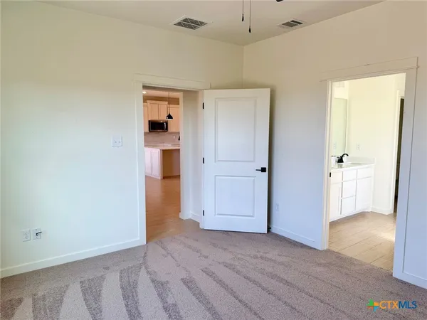 a view of bathroom with a sink cabinet and mirror