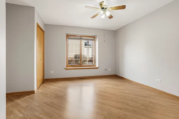 a view of an empty room with chandelier and a window
