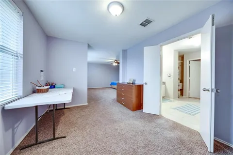 a spacious bathroom with a granite countertop sink and a mirror