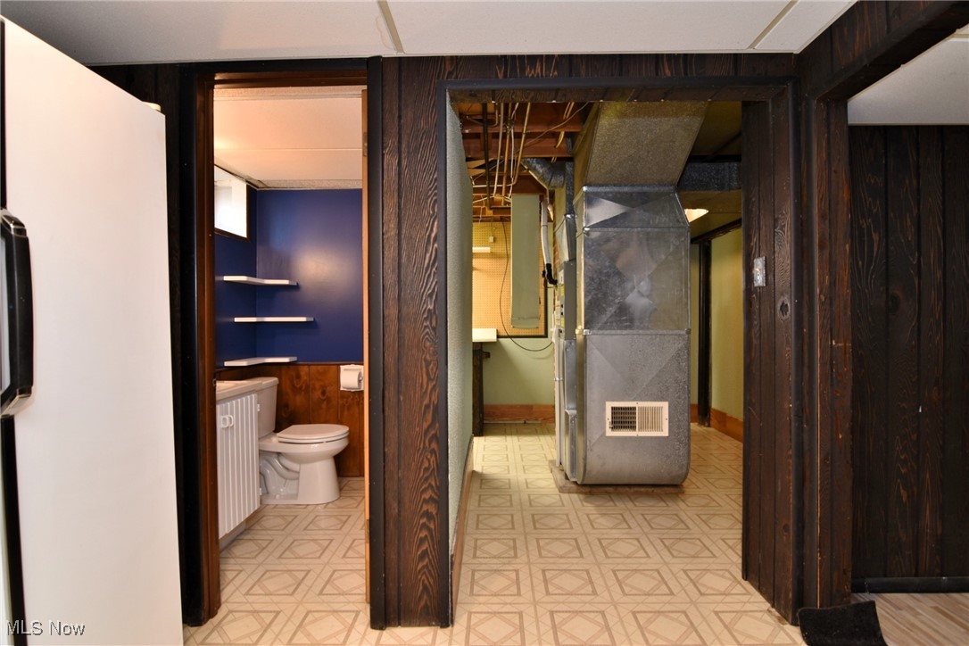 317 Nobottom Road Berea, OH 44017 - Photo 39 of 49 Bathroom featuring vanity, toilet, electric panel, and tile patterned flooring