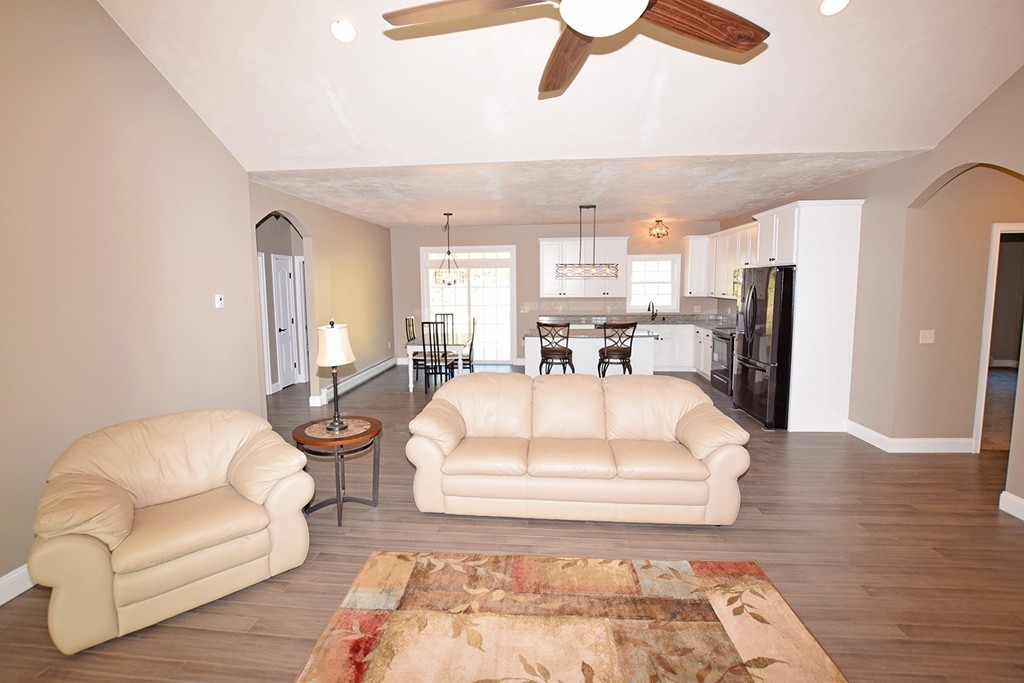 70 New Salem Road Petersham, MA 01366 - Photo 7 of 22 a spacious bedroom with a bed a couch and a chandelier