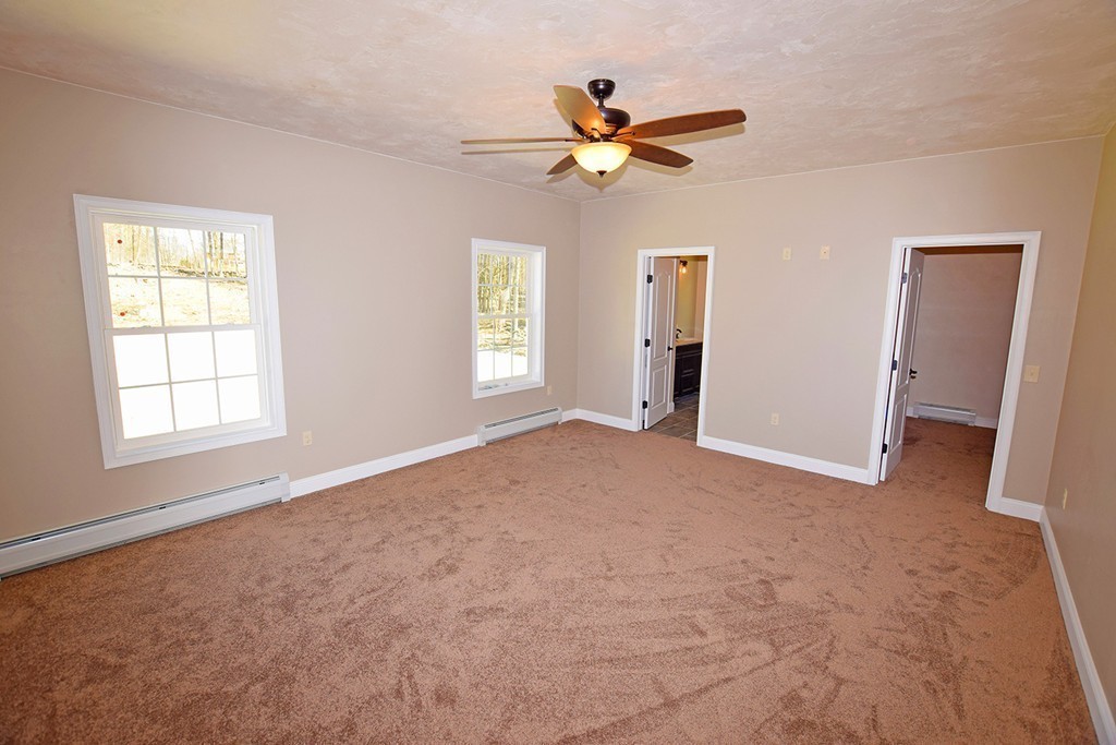 70 New Salem Road Petersham, MA 01366 - Photo 10 of 22 an empty room with windows and fan