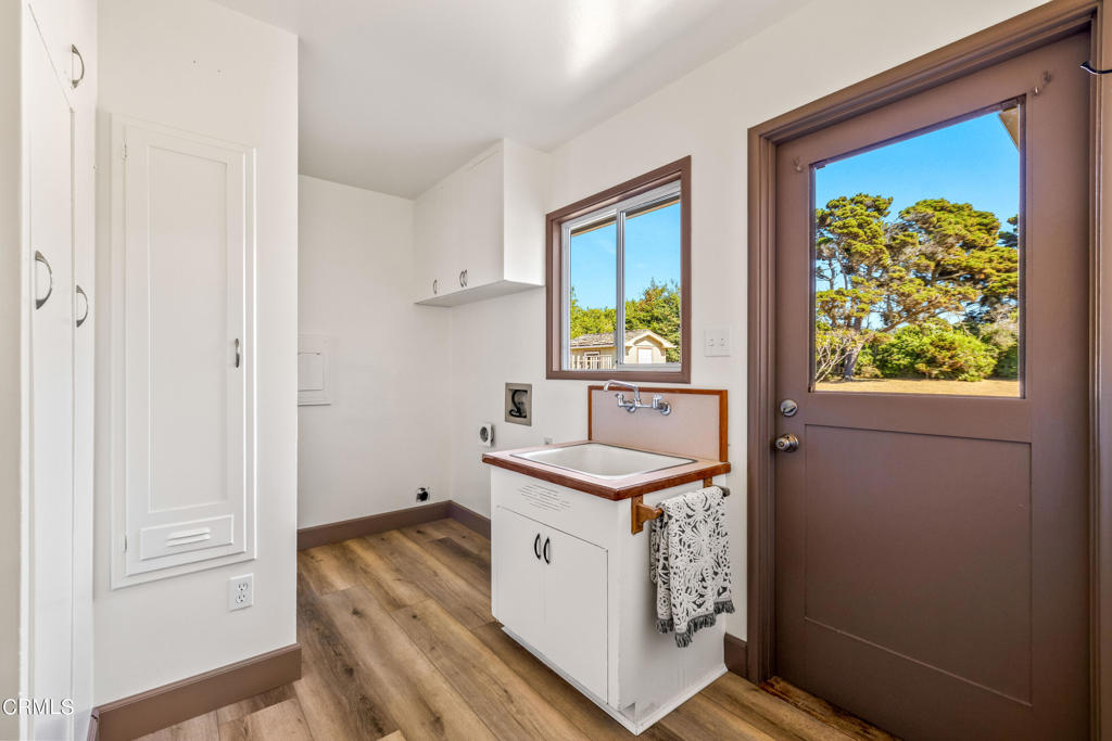 18601 Cypress Road Fort Bragg, CA 95437 - Photo 28 of 35 a utility room with a sink a cabinetry and a window