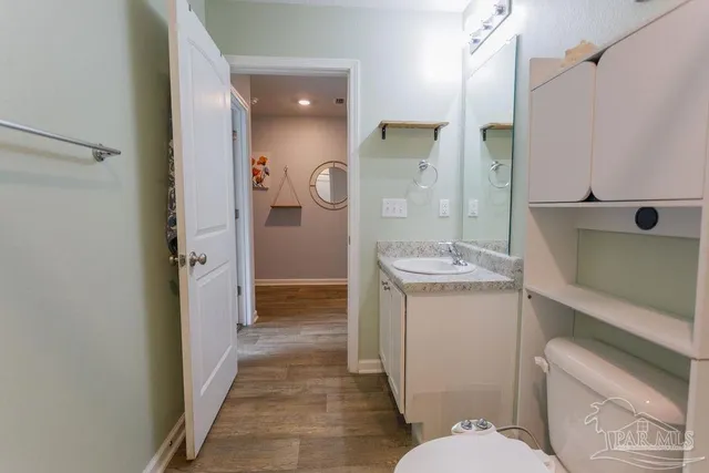 a bathroom with a sink a toilet a mirror and shower