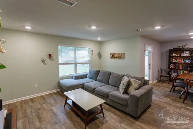 a living room with furniture and a window